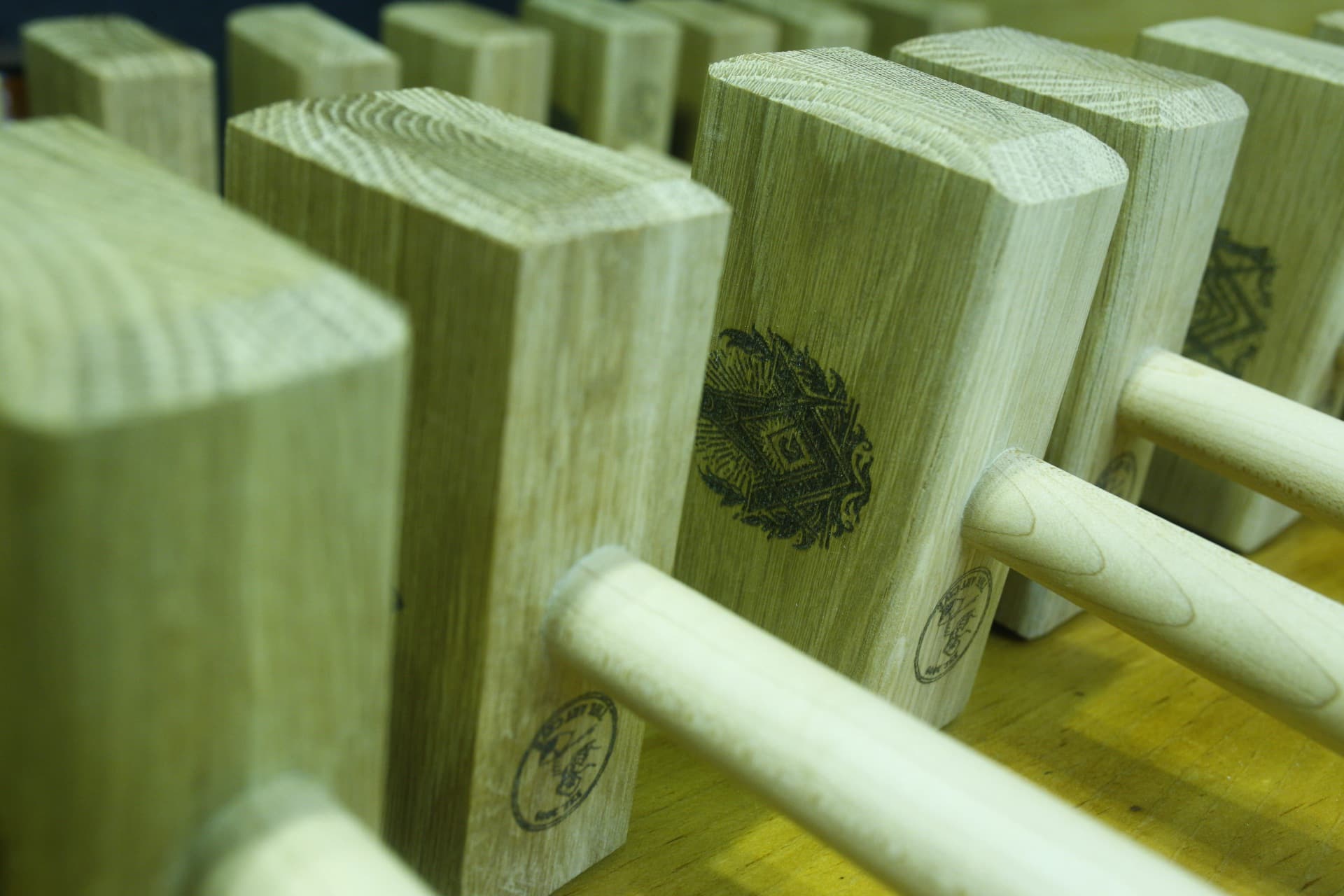 The maker's hands shaping hardwood at the bench in the Niagara workshop